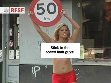 Bikini Bandit holds a 50 km speed limit sign
