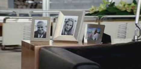 Photographs on desk in White Ribbon Day TV Ad