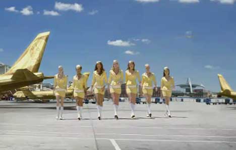 Mostesses walk on the tarmac by a Lynx Jet plane