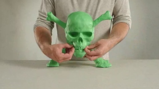 Green claymation skull in Xbox Bluckbusters ad