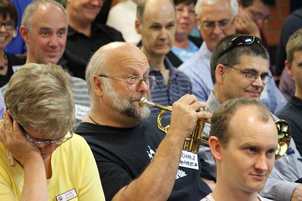 John Squires plays the trumpet at A Caler Call conference